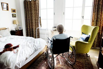 Elderly person in room at nursing home