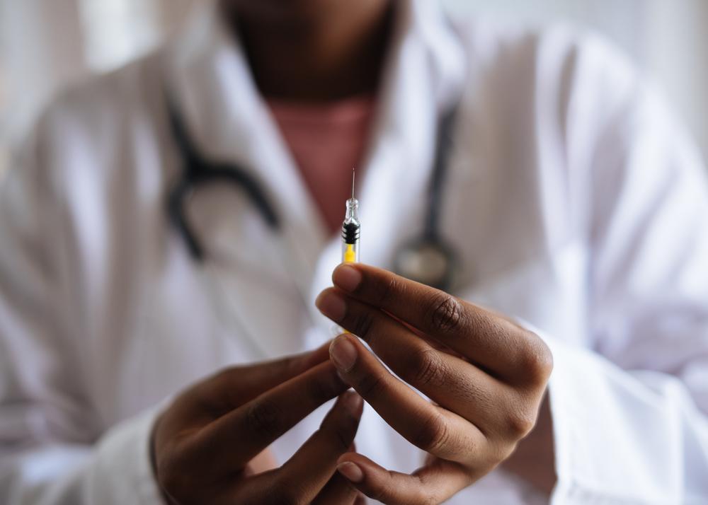 person holding syringe