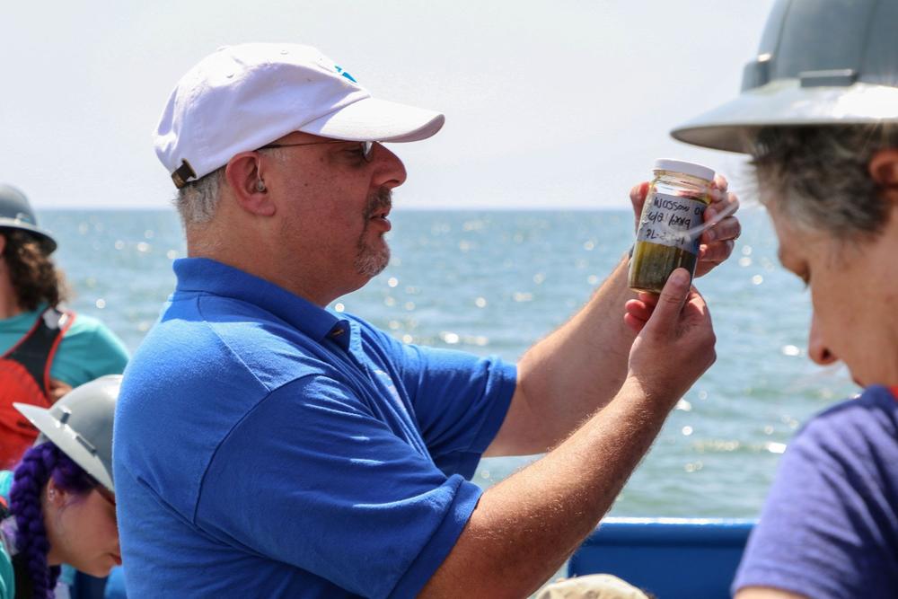 Marc Frischer examines sediment on a black gill cruise.