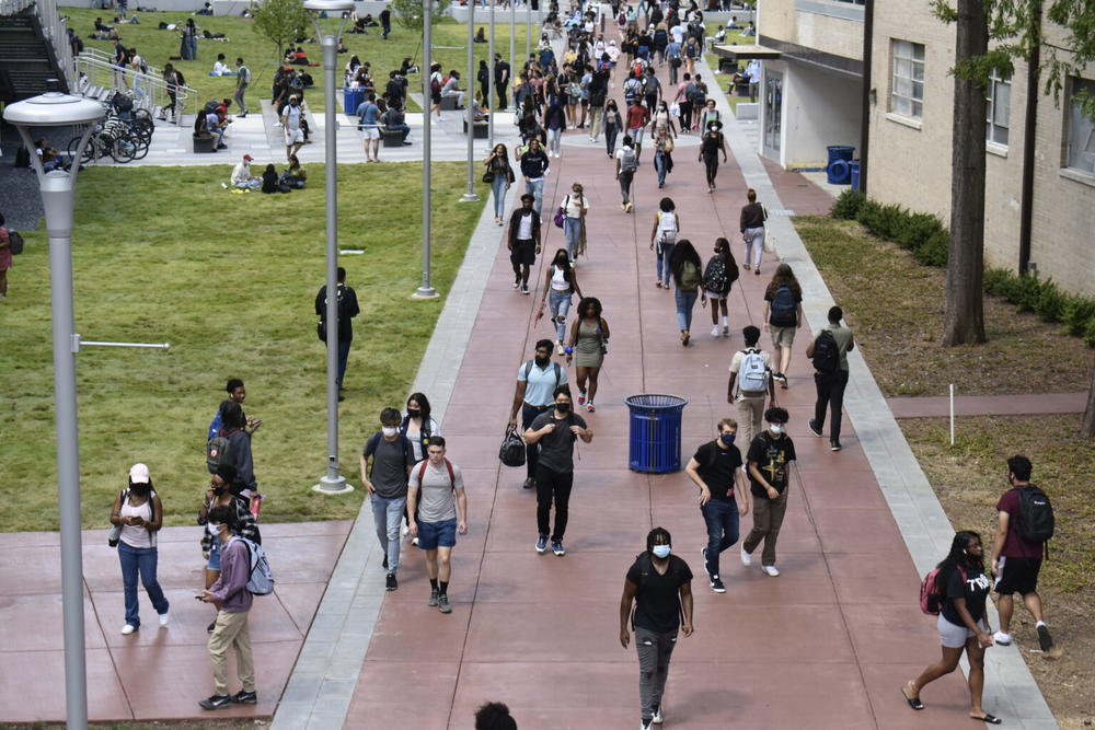 Georgia State University students walk the campus Monday. Some professors are hoping to mandate masks for these students inside campus buildings. 