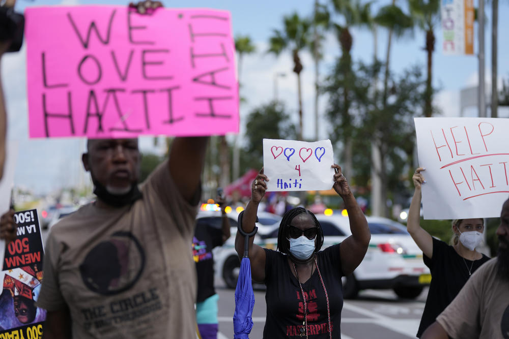 Members of Miami's Haitian community and other supporters protest against the deportation of Haitians arriving at the U.S. border, Wednesday, Sept. 22, 2021, outside the offices of the U.S. Citizenship and Immigration Services in Miami. 