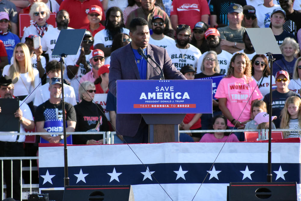 Former University of Georgia football standout Herschel Walker speaks at a rally in Perry, Ga.