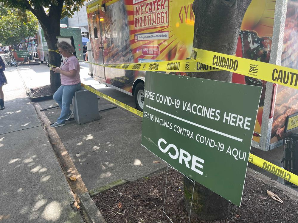 A sign offers COVID-19 vaccines at Dragon Con 2021.