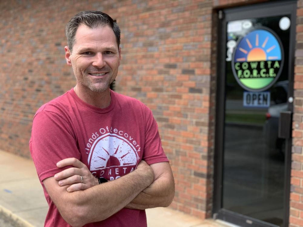 Hank Arnold, executive director of Coweta F.O.R.C.E. in Newnan, stands in the center’s meeting room. The group is one of 38 recovery community organizations across the state.