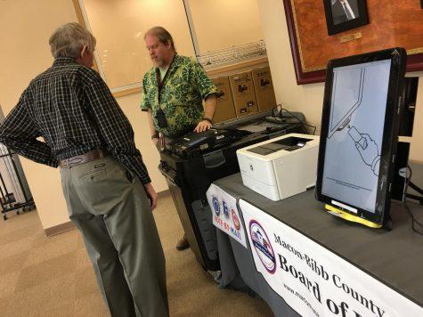 Macon-Bibb County elections officer Thomas Gillon demonstrates the new voting machines at the board of elections office on Pio Nono Avenue.