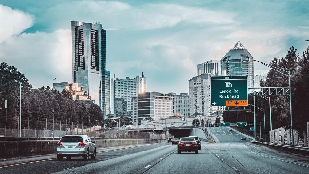 Cars on Road Near City Buildings