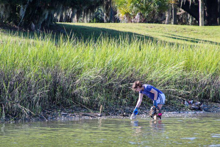 Sarah Roney places her bagged oysters in the Skidaway River. The research on the effect of “fear chemicals” on the growth of oysters could lead better opportunities to create living shorelines in Georgia. 