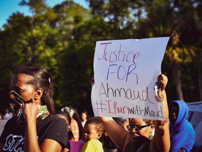 A protestor holds up a sign at a protest.