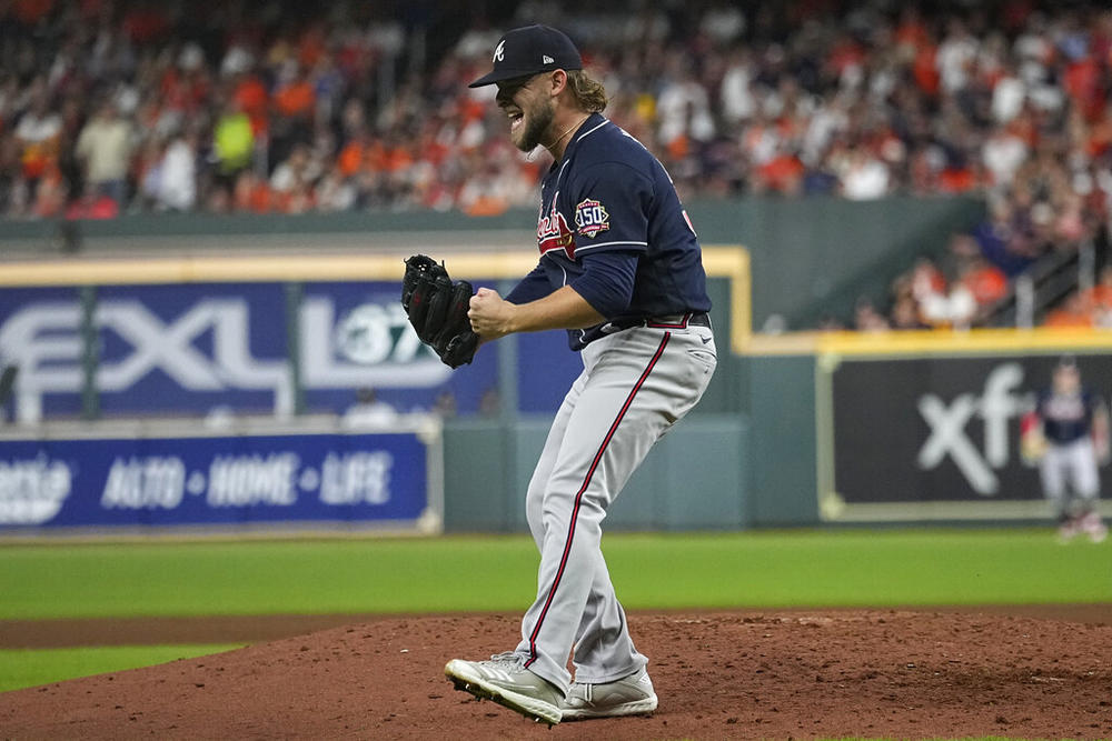 Atlanta Braves relief pitcher A.J. Minter celebrates the end of the third inning of Game 1 in baseball's World Series between the Houston Astros and the Atlanta Braves Tuesday, Oct. 26, 2021, in Houston. 