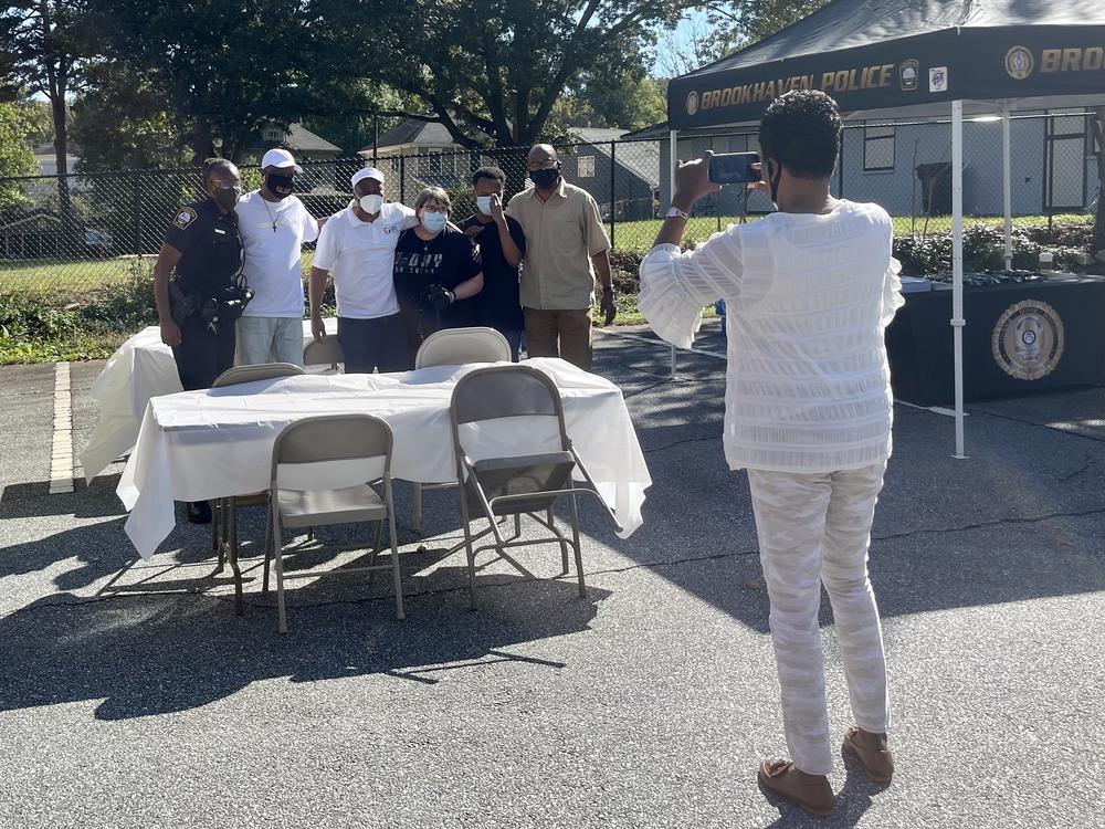 Janice Duncan captures a photo of law enforcement and community members at the Faith and Food Trucks event.