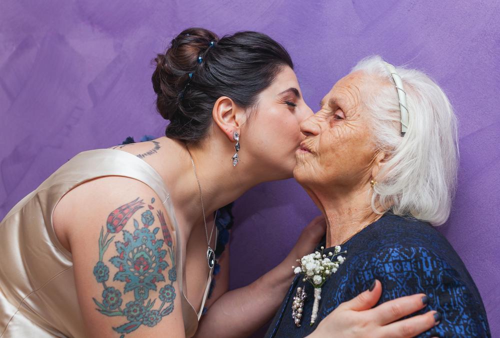 woman kisses the cheek of an older woman