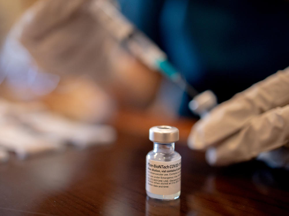 A health care worker prepares third doses of Pfizer-BioNTech COVID-19 vaccines for a senior living facility in Worcester, Pa., in late August.