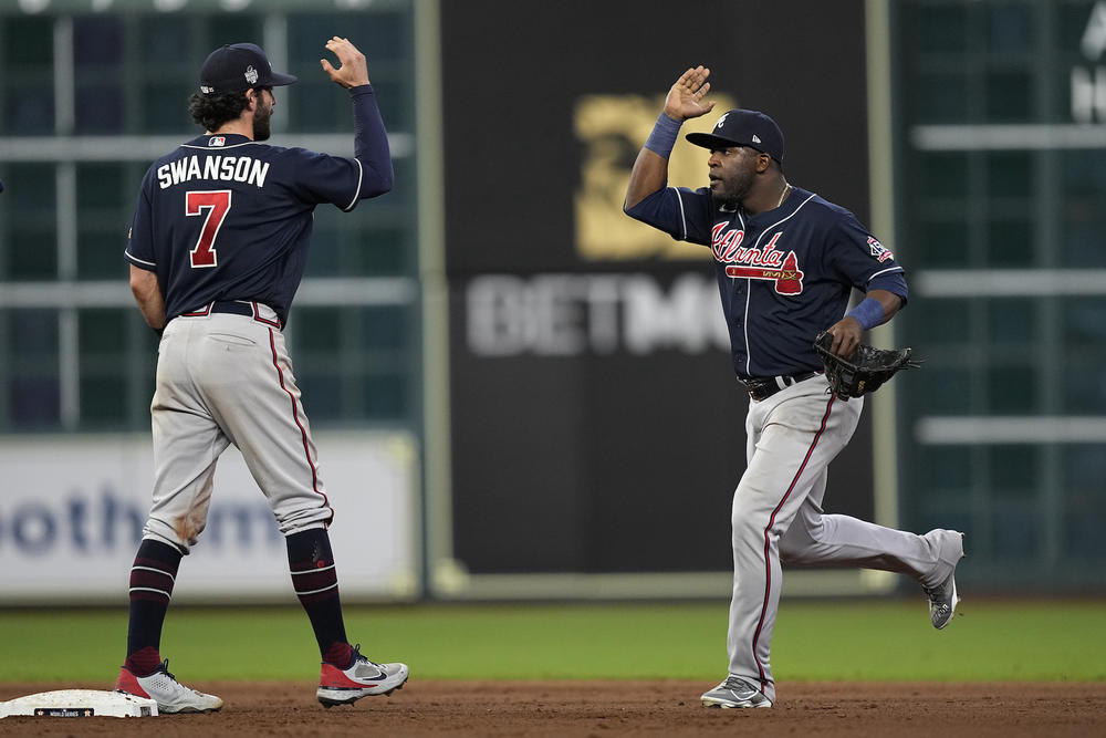 Atlanta Braves center fielder Guillermo Heredia and shortstop Dansby Swanson celebrates their win against the Houston Astros in Game 1 of baseball's World Series between the Houston Astros and the Atlanta Braves Tuesday, Oct. 26, 2021, in Houston. The Braves won 6-2. 