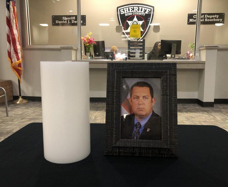 A tribute to Sgt. William “Bill” Gay sits in the lobby of the Bibb County Sheriff’s Annex Building after his death from COVID-19.