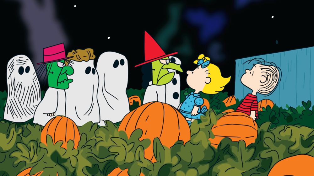 The Peanuts gang in costume at a pumpkin patch.