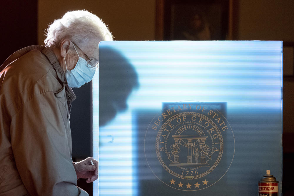 In this Jan. 5, 2021, file photo, Helen Thomason marks her ballot at the Lawrenceville Road United Methodist Church in Tucker, Ga. during the Senate runoff election