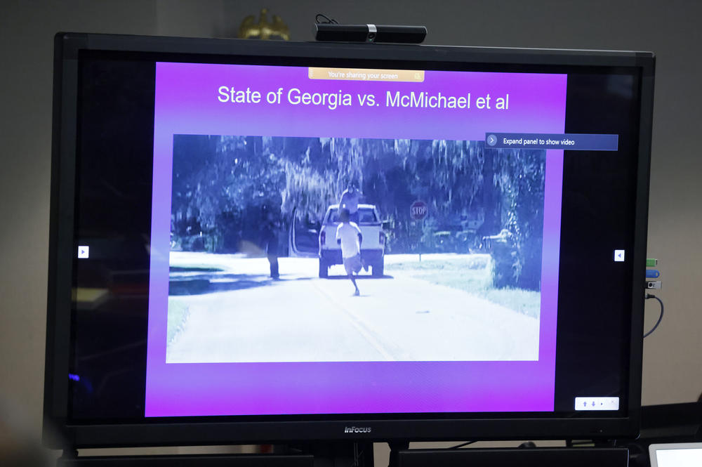 The evidence is played on a screen during opening statements in the trial of Greg McMichael and his son, Travis McMichael, and a neighbor, William "Roddie" Bryan at the Glynn County Courthouse, Friday, Nov. 5, 2021, in Brunswick, Ga.