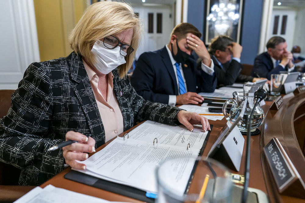 Rep. Michelle Fischbach, R-Minn., left, and Rep. Guy Reschenthaler, R-Pa., right, take their places on the dais as the House Rules Committee begins work on President Joe Biden's sweeping domestic agenda, the Build Back Better Act, at the Capitol in Washington, Wednesday, Nov. 3, 2021.