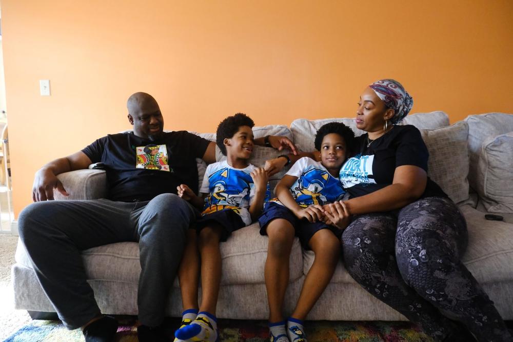 Bobby Henderson at home with his sons, Jasper, Ethan, and wife Sharise. Credit: Malcolm Jackson/For The Washington Post