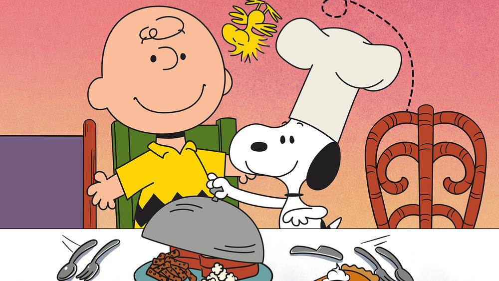 Charlie Brown and Snoopy at the table.