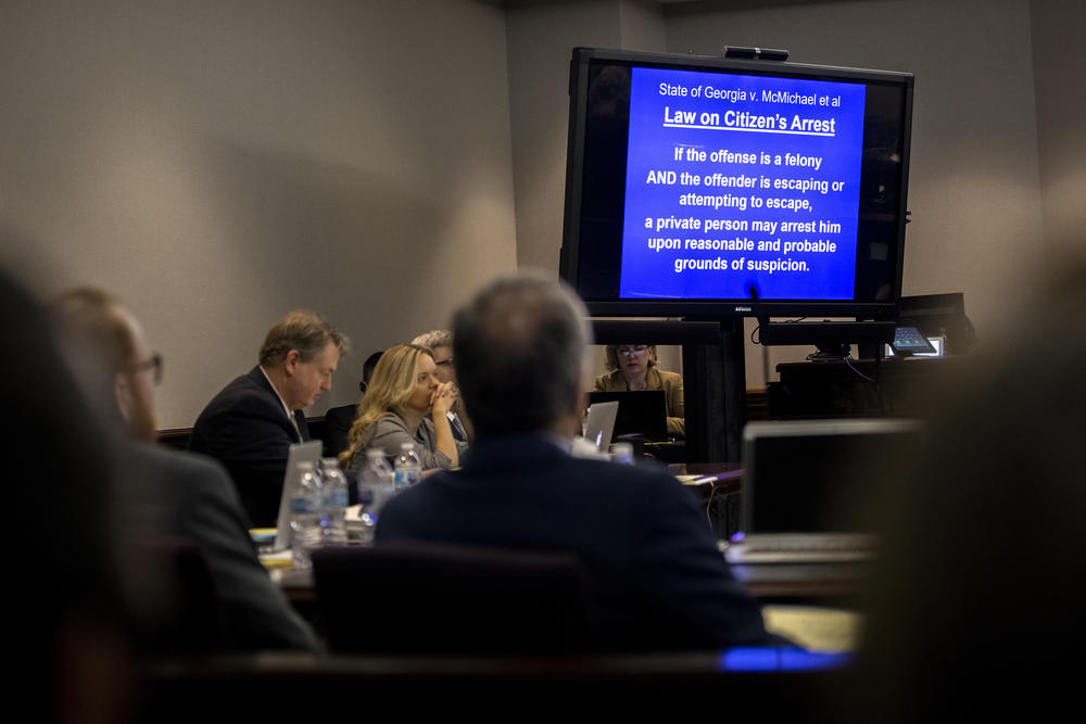 Defense attorney's listen prosecutor Linda Dunikoski's closing argument to the jury during the trial of Travis McMichael, his father, Gregory McMichael, and William "Roddie" Bryan, at the Glynn County Courthouse, Monday, Nov. 22, 2021, in Brunswick, Ga. 