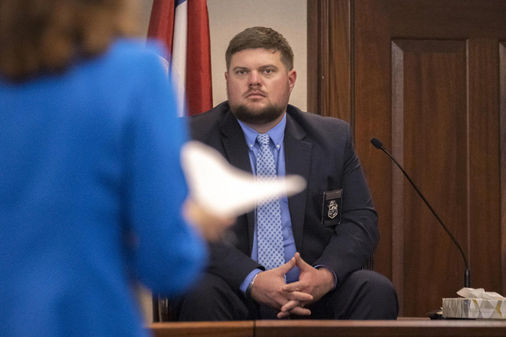 Glynn County Police Department Investigative Detective Parker Marcy sits on the witness stand during the trial of Greg McMichael and his son, Travis McMichael, and a neighbor, William "Roddie" Bryan in the Glynn County Courthouse, Tuesday, Nov. 9, 2021, in Brunswick, Ga.
