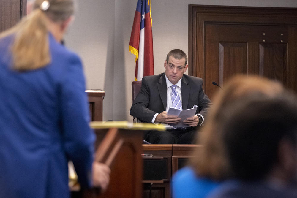 Glynn County Police Officer Jeff Brandeberry sits on the witness stand during the trial of Greg McMichael and his son, Travis McMichael, and a neighbor, William "Roddie" Bryan in the Glynn County Courthouse, Tuesday, Nov. 9, 2021, in Brunswick, Ga.