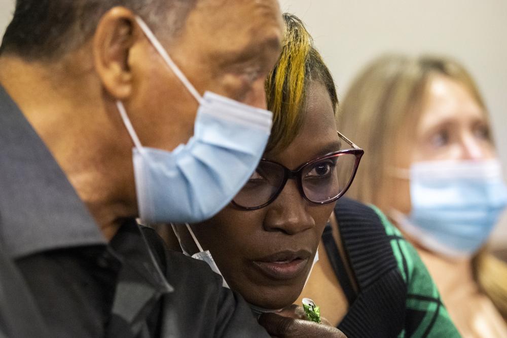 The Rev. Jesse Jackson, left, speaks with Ahmaud Arbery's mother, Wanda Cooper-Jones, center, during the trial of Greg McMichael and his son, Travis McMichael, and a neighbor, William "Roddie" Bryan in the Glynn County Courthouse, Monday, Nov. 15, 2021, in Brunswick, Ga.
