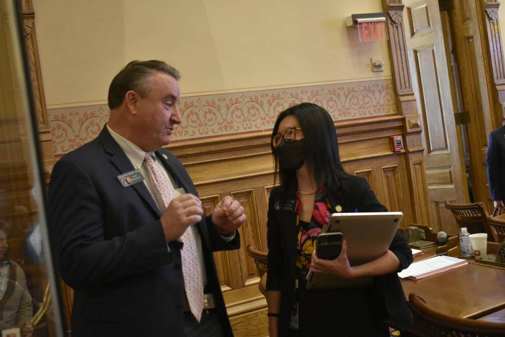 From left, Sens. Frank Ginn, a Republican from Danielsville, and Michelle Au, a Democrat from Johns Creek, talk on the Senate floor. Au is the only senator in a competitive district under the redistricting plan awaiting Gov. Kemp’s signature. 