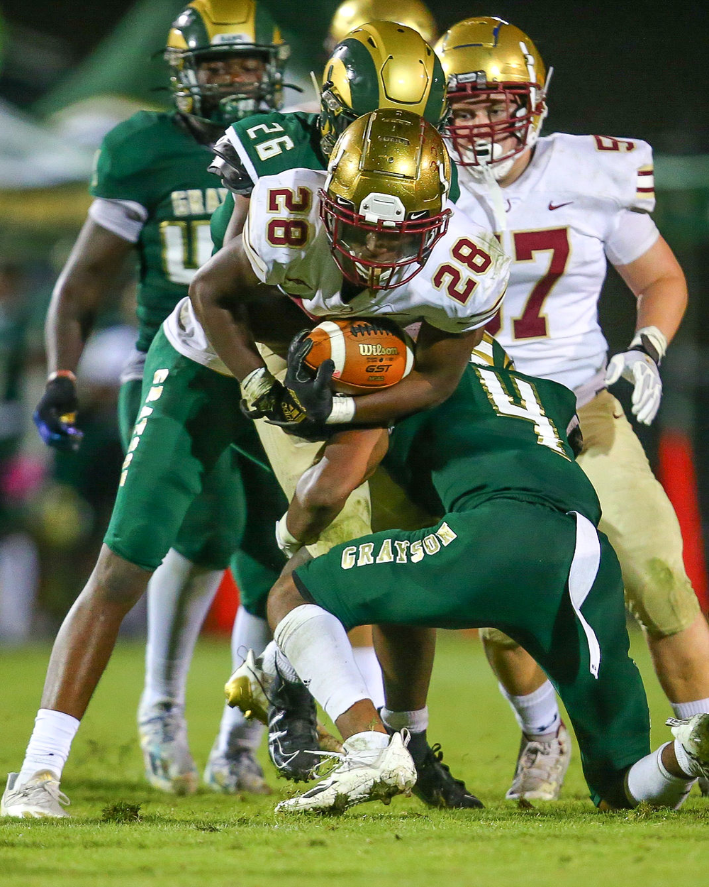 High school football teams Grayson (in green) and Brookwood contend on the field Oct. 22, 2021.