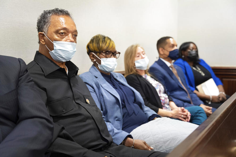 Rev. Jesse Jackson, left, sits with Wanda Cooper-Jones, mother of Ahmaud Arbery, during the trial of Arbery at the Glynn County Courthouse on Thursday, Nov. 18, 2021 in Brunswick, Ga. Travis McMichael, his father Greg McMichael, and a neighbor William "Roddie" Bryan are charged charged with the February 2020 slaying of 25-year-old Ahmaud Arbery.