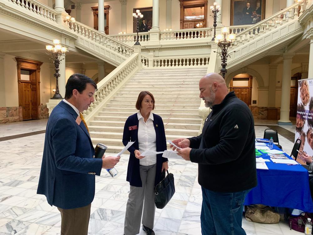 Jonathan Langston (right) speaks with Reps. Matthew Gambill and Angelika Kausche at the Georgia Capitol. 