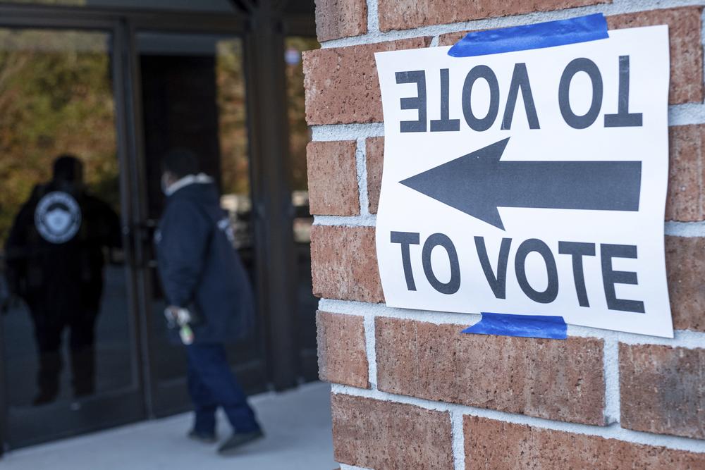 A voter enters Jackson Memorial Baptist Church to cast her vote during municipal elections in Atlanta on Tuesday, Nov. 2, 2021.