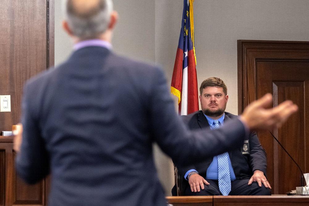 Travis McMichael's attorney Jason B. Sheffield, center, questions Glynn County Police Department Investigative Detective Parker Marcy, right, during the trial of Greg McMichael and his son, Travis McMichael, and a neighbor, William "Roddie" Bryan in the Glynn County Courthouse, Tuesday, Nov. 9, 2021, in Brunswick, Ga.