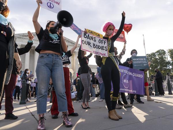 Abortion-rights supporters and opponents rally outside the Supreme Court in November, as the justices heard arguments about Texas' controversial abortion law.