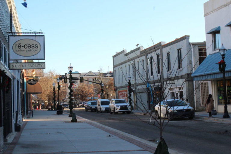 The renovations on downtown Gainesville include a sidewalk expansion project along Bradford Street which Chris Richardson, owner of Re-cess, is particularly happy about.