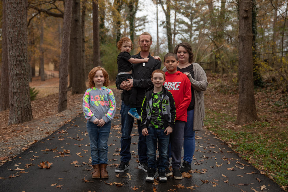 Hannah Ochoa poses for a portrait with her family in Marietta