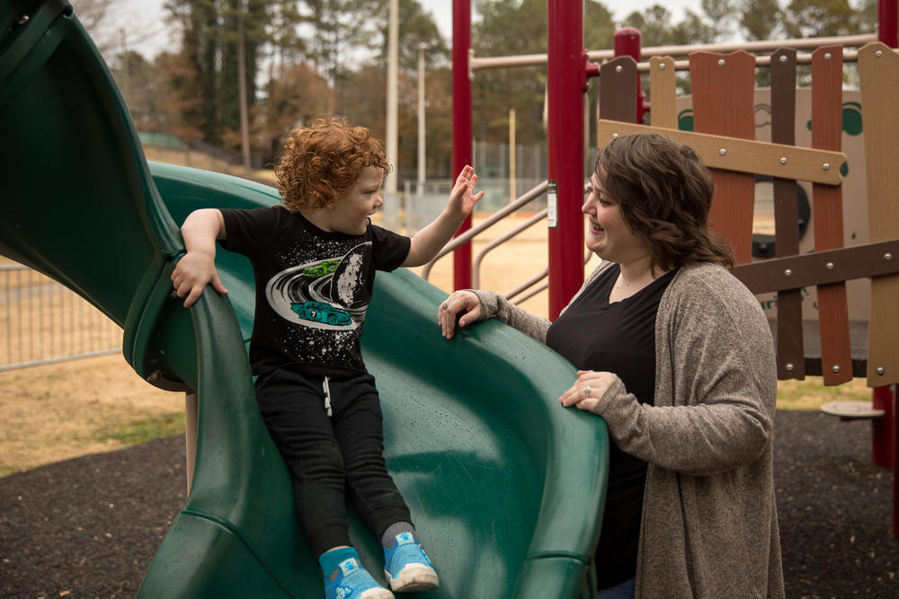 Hannah Ochoa plays with her family at a playground in Marietta