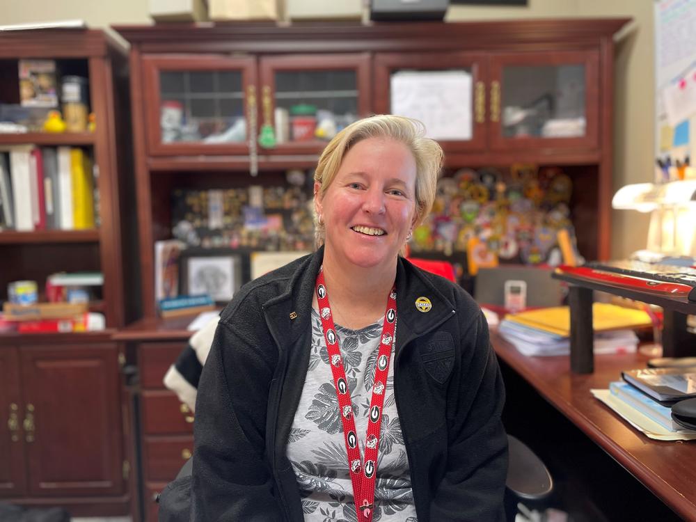 Cobb County 911 call center operations manager Kathy Stickland sits at the desk in her office. 