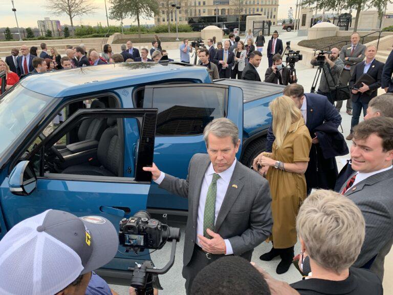  Gov. Brian Kemp steps out of a Rivian truck Thursday at a press event announcing the the electric vehicle maker will build a factory in Georgia. Jill Nolin/Georgia Recorder