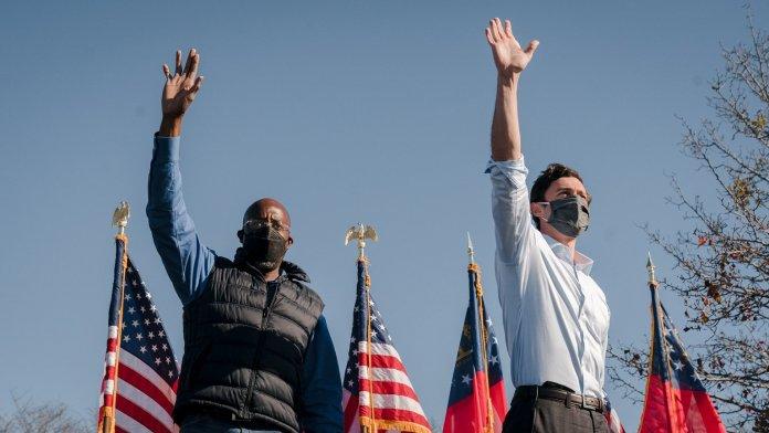 The Rev. Raphael Warnock and Jon Ossoff wave to the crowd from a joint campaign event ahead of the Jan. 5 runoff. Photo courtesy of Jon Ossoff for Senate