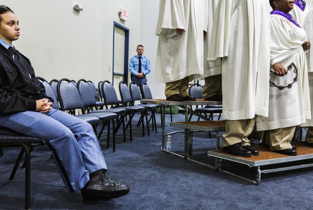 Guards from Lee Arrendale State Prison watch as the prison's choir performs in Macon in 2017 during the signing of prison reform legislation by then Governor Nathan Deal. 