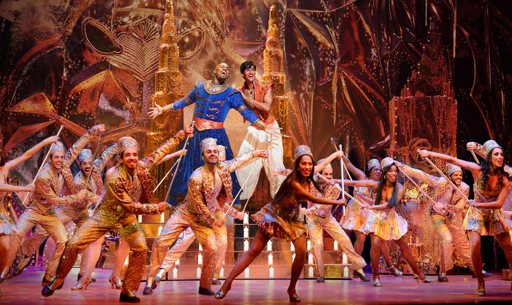 Broadway cast of Aladdin on stage.