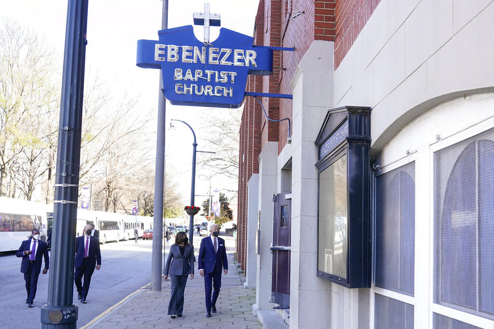 President Joe Biden and Vice President Kamala Harris walk as they arrive for a visit to Ebenezer Baptist Church, Tuesday, Jan. 11, 2022, in Atlanta.
