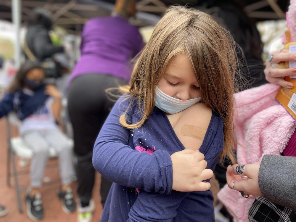 5-year-old Vivian Dominguez shows off her Band-Aid after getting a Pfizer COVID-19 shot from a Louisiana Department of Health vaccine clinic in New Orleans.
