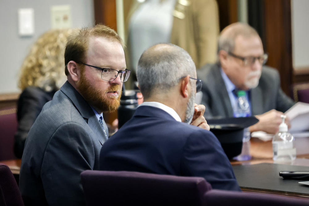 Travis McMichael, left, speaks with his attorney Jason B. Sheffield , center, during his sentencing, alone with his father Greg McMichael and neighbor, William "Roddie" Bryan in the Glynn County Courthouse, Friday, Dec. 7, 2022, in Brunswick, Ga. The three found guilty in the February 2020 slaying of 25-year-old Ahmaud Arbery.