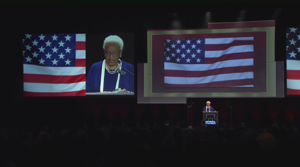 Gloria Butler stands on stage during the Eggs and Issues breakfast.