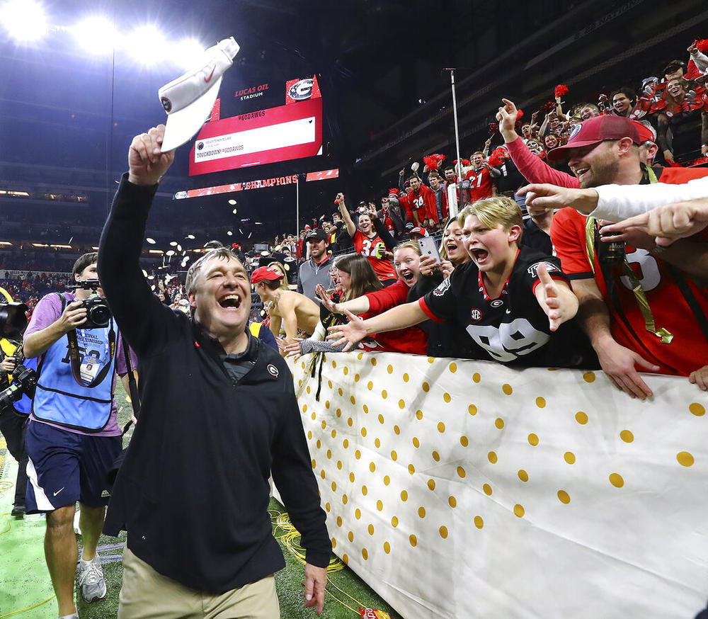 Georgia head coach Kirby Smart celebrates with fans after beating Alabama 33-18 in the College Football Playoff championship game, early Tuesday, Jan. 11, 2022, in Indianapolis.