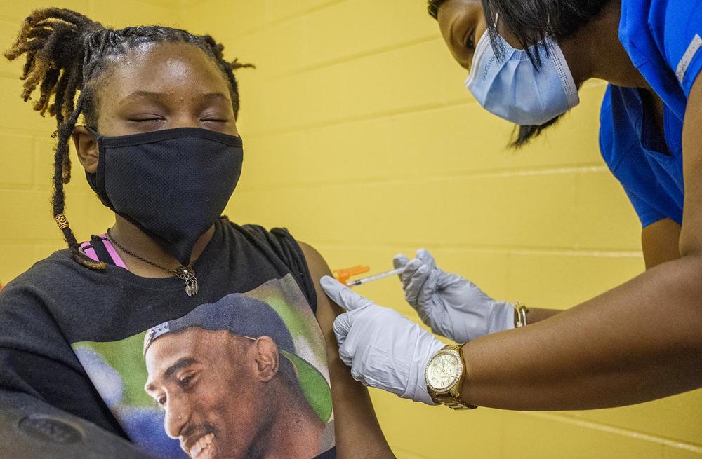 Bibb County middle school student Sade Veal gets her first dose of the Pfizer COVID vaccine at a back to school event sponsored by Bibb County Schools in 2021. 