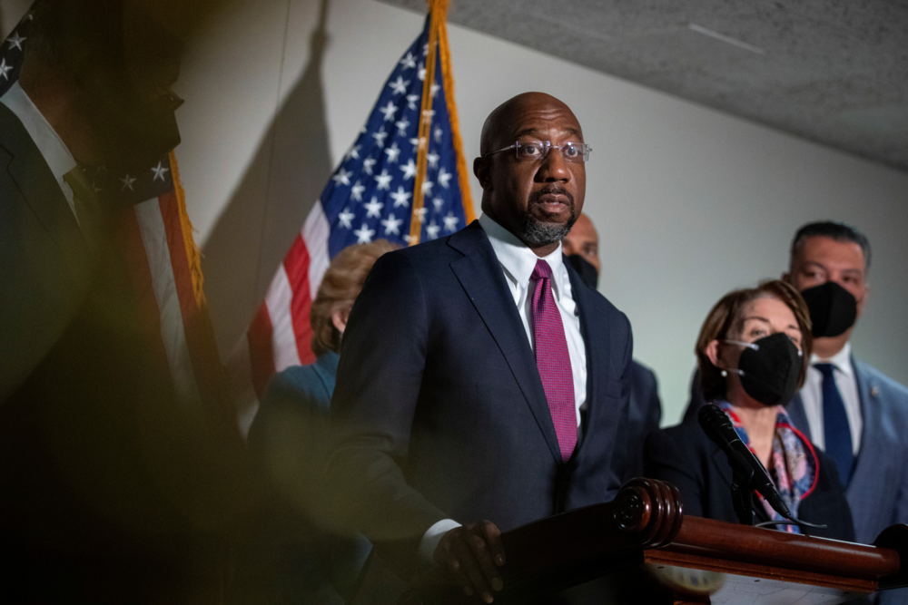Sen. Raphael Warnock, D-Ga., speaks to reporters alongside Sen. Cory Booker, D-N.J., and Sen. Amy Klobuchar, D-Minn., and Sen. Alex Padilla, D-Calif., during a press conference regarding the Democratic party's shift to focus on voting rights at the Capitol in Washington, Tuesday, Jan. 18, 2022. 